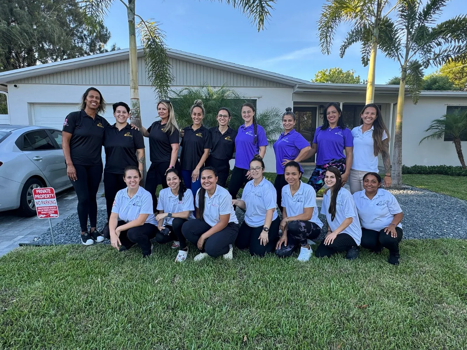 The Wizard Cleaning team in uniform in front of a Florida home